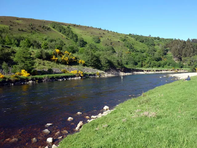 A scenic river flowing through a picturesque valley.