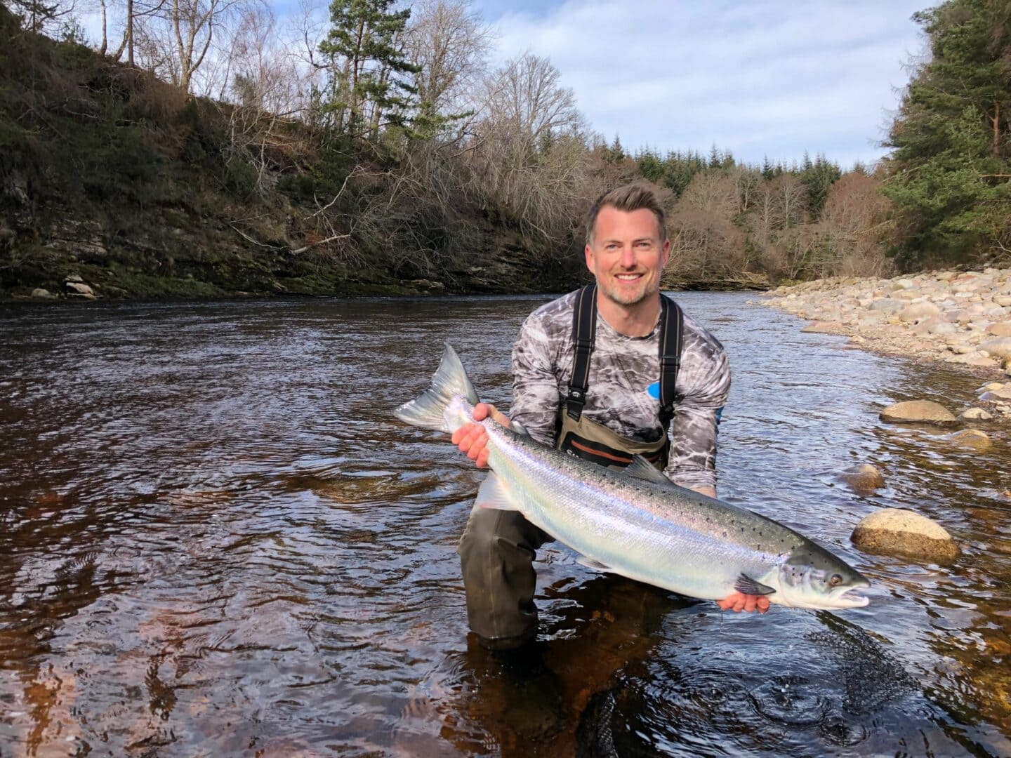 James Stokoe lifts up his first ever Scottish salmon of around 18 lbs. from Palamore Pool, Altyre Estate, River Findhorn.