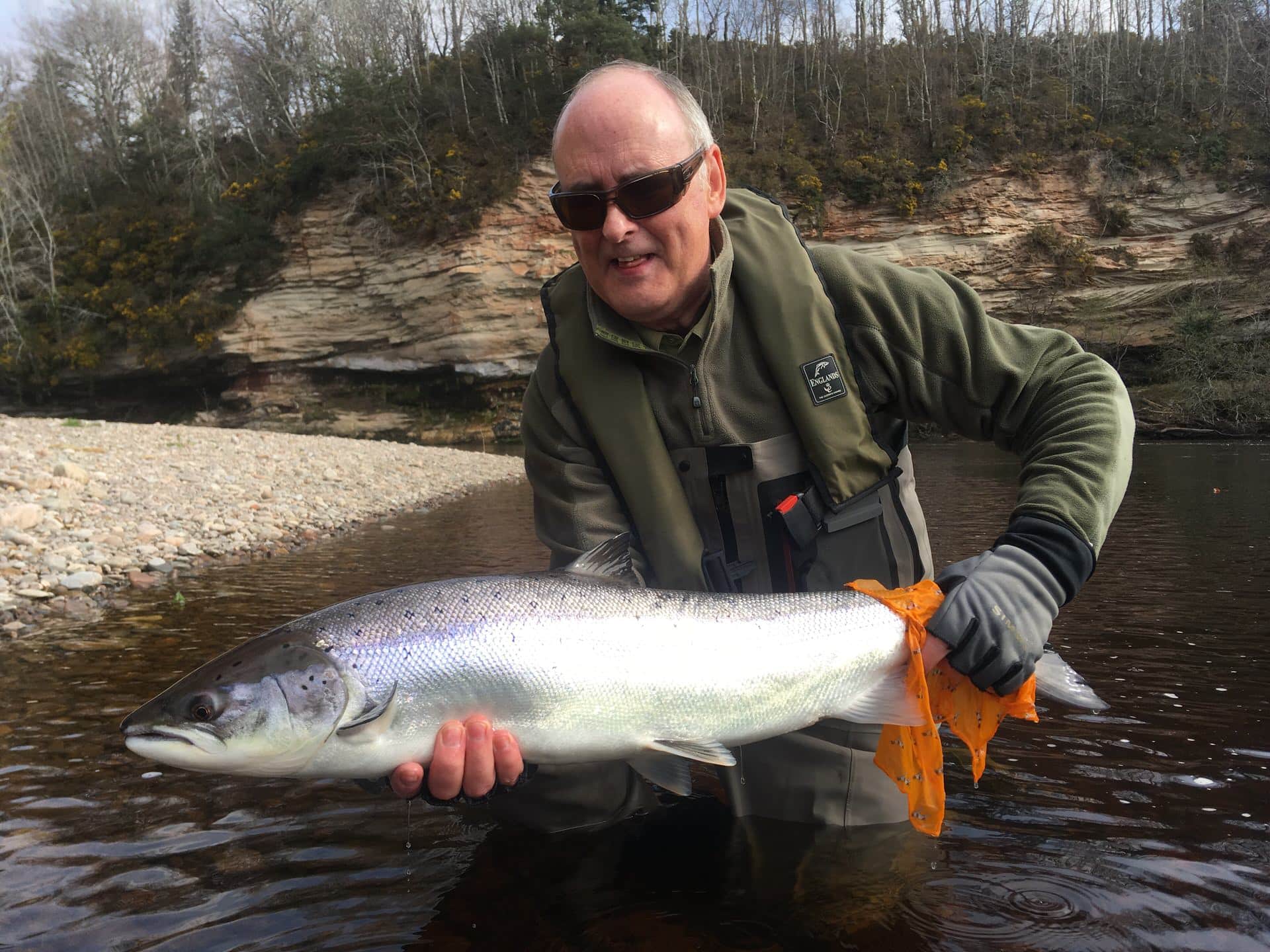 A happy angler holding a fresh Spring salmon from the River Findhorn.