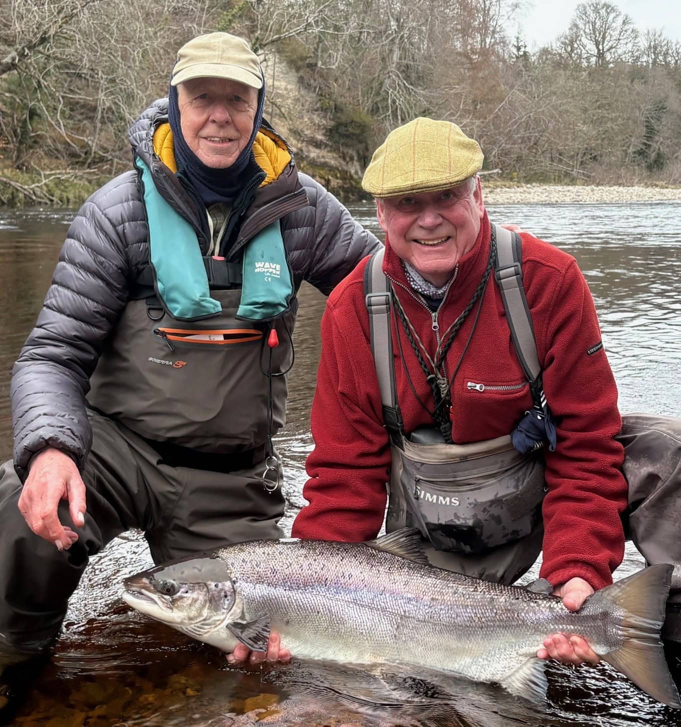 Two anglers with a large spring Atlantic salmon on the River Findhorn